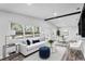 Inviting living room with white sofa and blue accents, adjacent to dining area with large windows at 505 Lake Shore Dr, Maitland, FL 32751