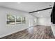 Bright living room with luxury vinyl plank flooring and natural light from large windows at 505 Lake Shore Dr, Maitland, FL 32751