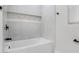 The modern shower features gray and white tile work, a built-in shelf, and matte black fixtures at 505 Lake Shore Dr, Maitland, FL 32751