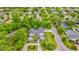 A high angle view of the home from above, showcasing the meticulously maintained landscape and surrounding trees at 532 Worthington Dr, Winter Park, FL 32789