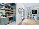 Stylish bar area featuring elegant cabinetry, open shelving, a wine fridge, and decorative tile at 532 Worthington Dr, Winter Park, FL 32789