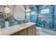 This bathroom features beautiful blue tile and a glass shower door at 532 Worthington Dr, Winter Park, FL 32789