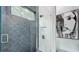 Stunning bathroom shower featuring dual-toned subway tiles and a rain shower head, with modern glass door at 532 Worthington Dr, Winter Park, FL 32789
