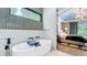 Modern bathroom featuring a soaking tub with a stylish, adjacent bedroom view at 532 Worthington Dr, Winter Park, FL 32789
