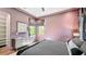 Bedroom featuring mauve walls, natural light, a modern dresser, and sophisticated window treatments at 532 Worthington Dr, Winter Park, FL 32789