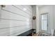 Welcoming entryway featuring horizontal shiplap accent wall and a bench with access to the outdoors at 532 Worthington Dr, Winter Park, FL 32789