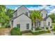 Stunning two-story home with a well-manicured lawn, featuring a modern design, dark framed windows and a metal roof at 532 Worthington Dr, Winter Park, FL 32789