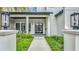 Close up view of the front entrance with modern design, black door and side lights at 532 Worthington Dr, Winter Park, FL 32789
