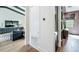 Hallway with hardwood floors that connects the living room and a bedroom, showcasing the home's open layout at 532 Worthington Dr, Winter Park, FL 32789