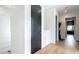 Bright hallway featuring hardwood floors, black doors, leading to other areas of the home at 532 Worthington Dr, Winter Park, FL 32789