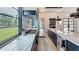Open kitchen boasts marble countertops, a sleek island, and a large window with views of the outdoors at 532 Worthington Dr, Winter Park, FL 32789