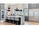 Modern kitchen featuring a large island, stainless steel fridge, and sleek, modern lighting at 532 Worthington Dr, Winter Park, FL 32789