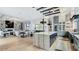 Open-concept kitchen with a large island, dining area, and a view of the living room fireplace at 532 Worthington Dr, Winter Park, FL 32789
