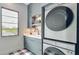This laundry room features a stacked washer and dryer, and a utility sink at 532 Worthington Dr, Winter Park, FL 32789