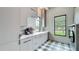 Bright laundry room with stylish cabinets, modern appliances, and a view of the outside at 532 Worthington Dr, Winter Park, FL 32789
