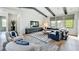 Elegant living room featuring exposed beams, modern decor, comfortable seating, and stylish furniture at 532 Worthington Dr, Winter Park, FL 32789