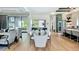 Open concept Living Room includes hardwood floors, large dining table, and direct access to the patio at 532 Worthington Dr, Winter Park, FL 32789