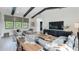 A spacious living room features a gray sectional, high ceilings with dark beams, and natural light from large windows at 532 Worthington Dr, Winter Park, FL 32789