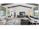 Bright living room features a gray sofa, natural light, decorative rug, and high ceilings with dark wood beams at 532 Worthington Dr, Winter Park, FL 32789