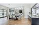 Bright living room and dining area featuring a fireplace, built-in shelving, and hardwood floors at 532 Worthington Dr, Winter Park, FL 32789