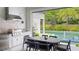 Outdoor kitchen features a built in grill, dining area, and a relaxing view of the backyard pool at 532 Worthington Dr, Winter Park, FL 32789