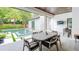 Outdoor kitchen with a built in grill, dining area, and a relaxing view of the backyard pool and patio at 532 Worthington Dr, Winter Park, FL 32789