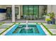 Elegant outdoor kitchen space overlooking a beautiful backyard pool and water feature at 532 Worthington Dr, Winter Park, FL 32789