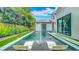 Modern backyard pool featuring a jacuzzi, lounge chairs, and a beautiful outdoor shower at 532 Worthington Dr, Winter Park, FL 32789