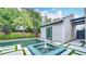 Backyard pool with built-in water feature, outdoor shower, and lush landscaping providing privacy at 532 Worthington Dr, Winter Park, FL 32789