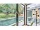 Inviting pool with lush landscaping, seen through sliding glass doors at 532 Worthington Dr, Winter Park, FL 32789