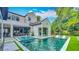 Gorgeous outdoor pool, equipped with a spa, lounge chairs, and an outdoor kitchen at 532 Worthington Dr, Winter Park, FL 32789