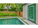 A refreshing backyard pool with an outdoor shower and lush greenery at 532 Worthington Dr, Winter Park, FL 32789