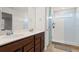 Bathroom featuring double vanities, quartz countertops, and a glass-enclosed shower at 5826 Wooden Pine Dr, Orlando, FL 32829