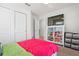 Bright bedroom featuring a TV, closet and display cabinet for toys, with ample storage at 5826 Wooden Pine Dr, Orlando, FL 32829