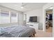 Well-lit bedroom with a ceiling fan, TV, and access to a walk-in closet at 5826 Wooden Pine Dr, Orlando, FL 32829