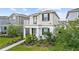 Attractive two-story home with a balcony and landscaped front yard at 5826 Wooden Pine Dr, Orlando, FL 32829