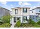 Two-story home featuring a charming balcony and well-maintained front yard at 5826 Wooden Pine Dr, Orlando, FL 32829