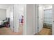 Hallway view showcasing bedroom and bathroom doors, highlighting the home's layout at 5826 Wooden Pine Dr, Orlando, FL 32829