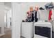 Functional laundry room with modern Maytag washer and dryer, plus overhead storage at 5826 Wooden Pine Dr, Orlando, FL 32829