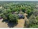 View of the home nestled among mature trees on a spacious lot at 6037 Lake Erie Rd, Groveland, FL 34736
