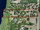 Expansive aerial view of the property, showcasing the lush greenery and serene lakefront location at 6037 Lake Erie Rd, Groveland, FL 34736