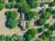 Stunning aerial view of a home nestled among mature trees and lush landscaping on a sprawling lot at 6037 Lake Erie Rd, Groveland, FL 34736