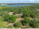 A beautiful home surrounded by lush greenery and mature trees with access to a pristine lake at 6037 Lake Erie Rd, Groveland, FL 34736