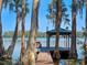 Secluded dock and charming gazebo overlooking the pristine lake, surrounded by mature trees at 6037 Lake Erie Rd, Groveland, FL 34736