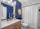Modern bathroom with a vanity, elegant mirror, and a bathtub/shower combination, exuding contemporary style at 6037 Lake Erie Rd, Groveland, FL 34736