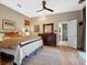Comfortable bedroom features a large bed, hardwood floors, dresser, and an ensuite bathroom with a walk-in shower at 6037 Lake Erie Rd, Groveland, FL 34736