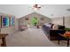 Bright bonus room with vaulted ceilings, a large window offering a view of nature, and neutral decor at 6037 Lake Erie Rd, Groveland, FL 34736
