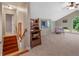 Bright bonus room with a vaulted ceiling, neutral carpet, and staircase at 6037 Lake Erie Rd, Groveland, FL 34736