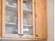 A detailed close-up of a wooden kitchen cabinet featuring glass doors and elegant dishware at 6037 Lake Erie Rd, Groveland, FL 34736