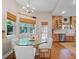 Open dining area with a glass table and chairs, seamlessly connected to the kitchen at 6037 Lake Erie Rd, Groveland, FL 34736